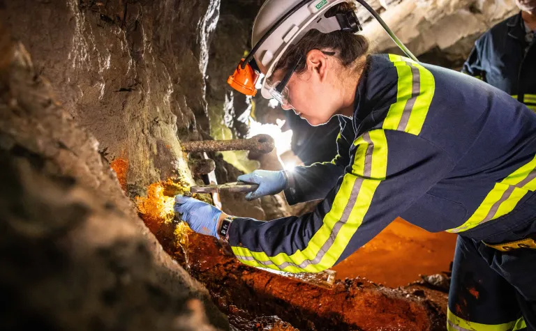 a scientists retrieves biologic samples from underground