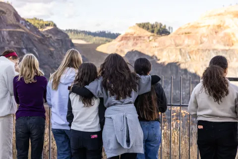 students looking out over the Open Cut in Lead at the Sanford Lab Homestake Visitor Center 