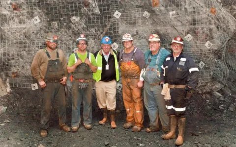 Six men stand in an underground cavern