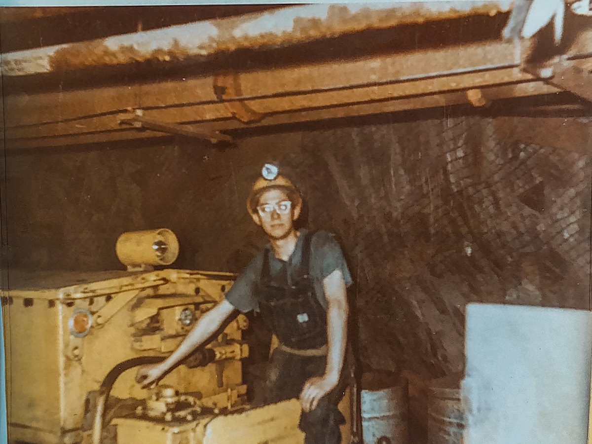 Dan Regan stands in a motor underground
