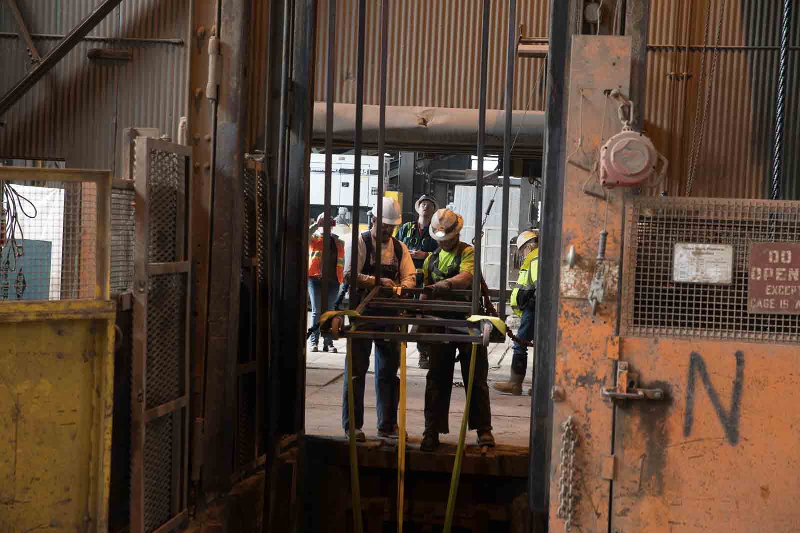 Rick Tinnel and Dustin Mund prepare to sling a load into a shaft.