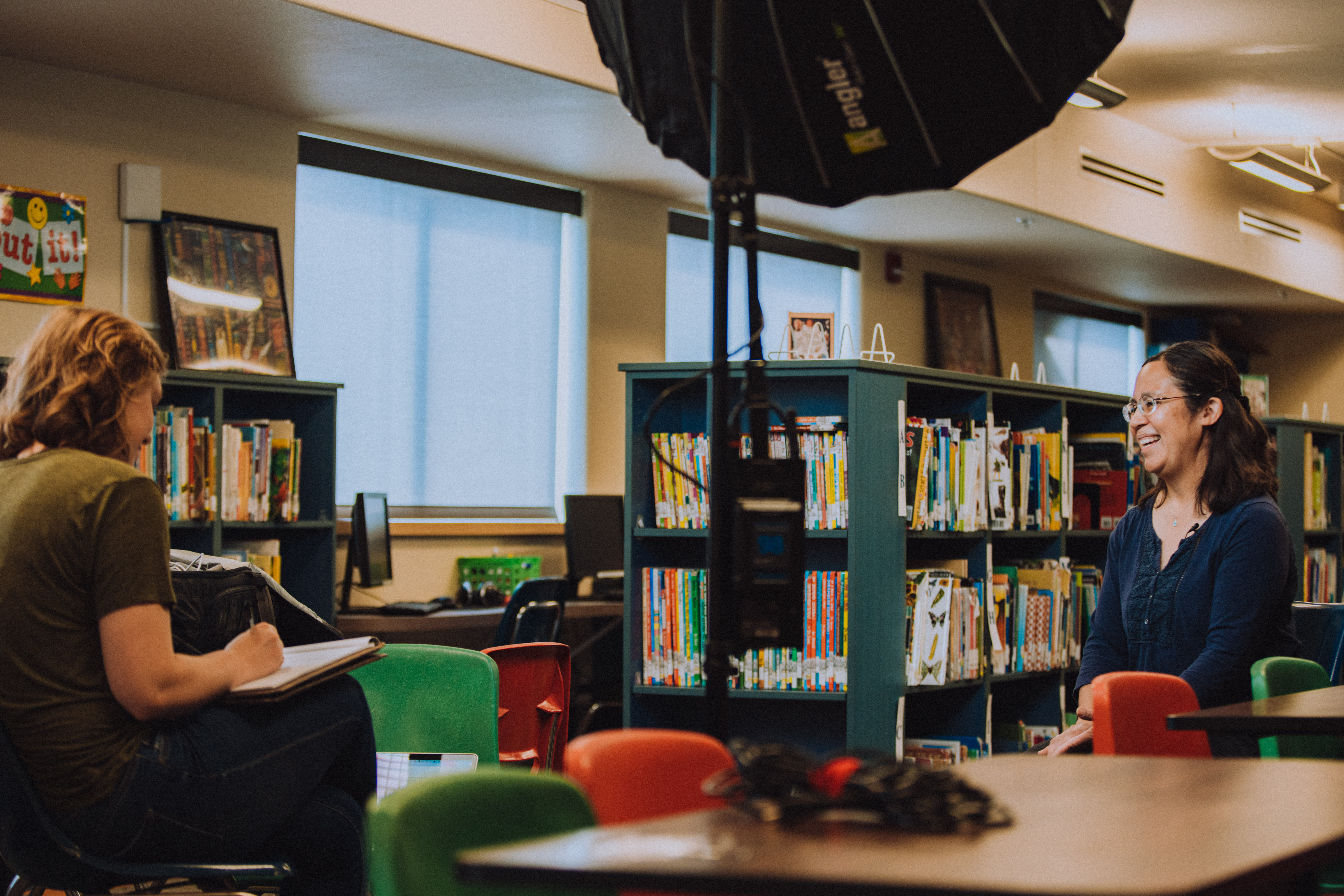 two people talk in a library