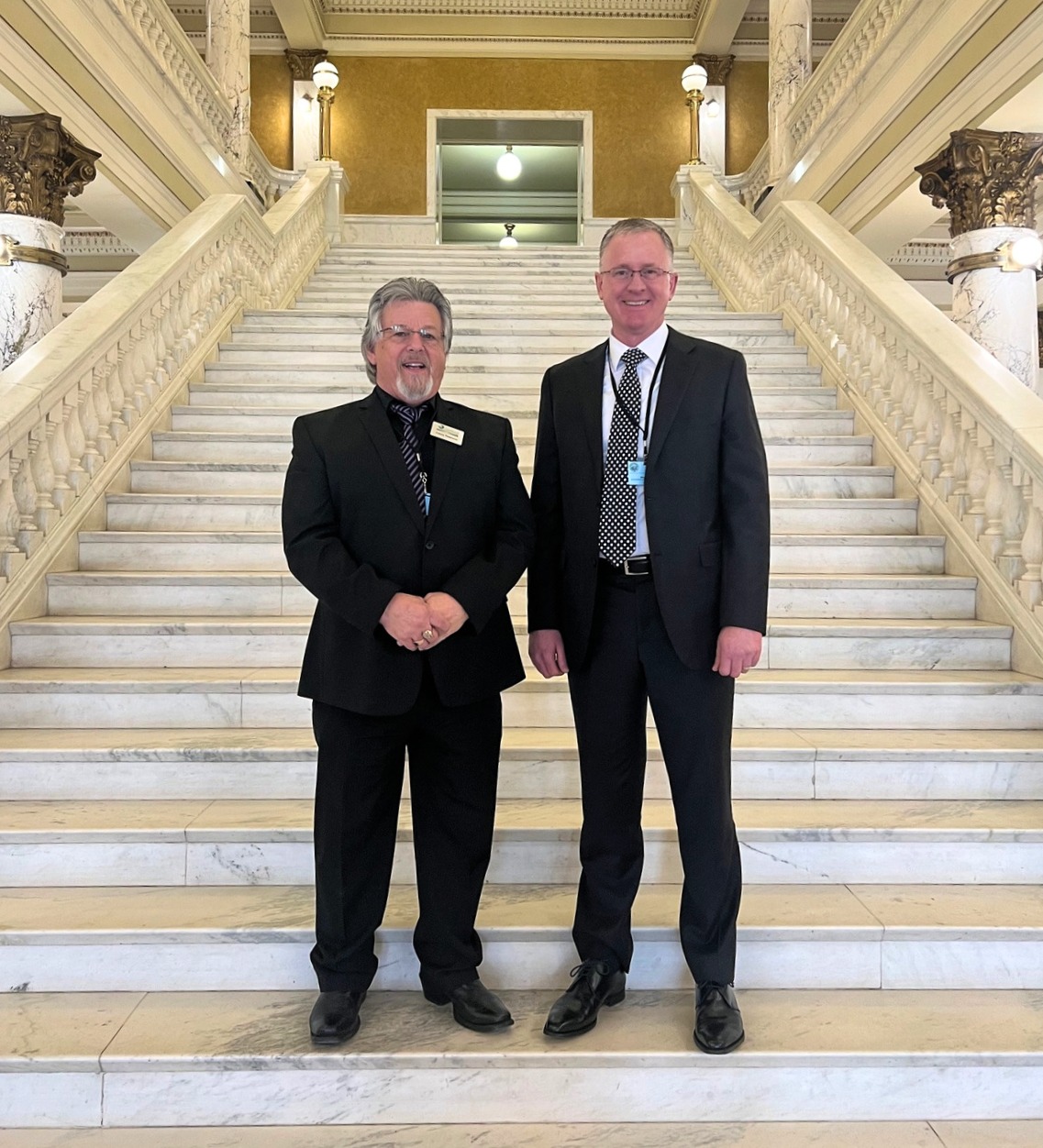 SDSTA chairperson Casey Peterson (left) and SDSTA executive director Mike Headley (right) stand on the steps of the South Dakota State Capitol in Pierre, South Dakota.
