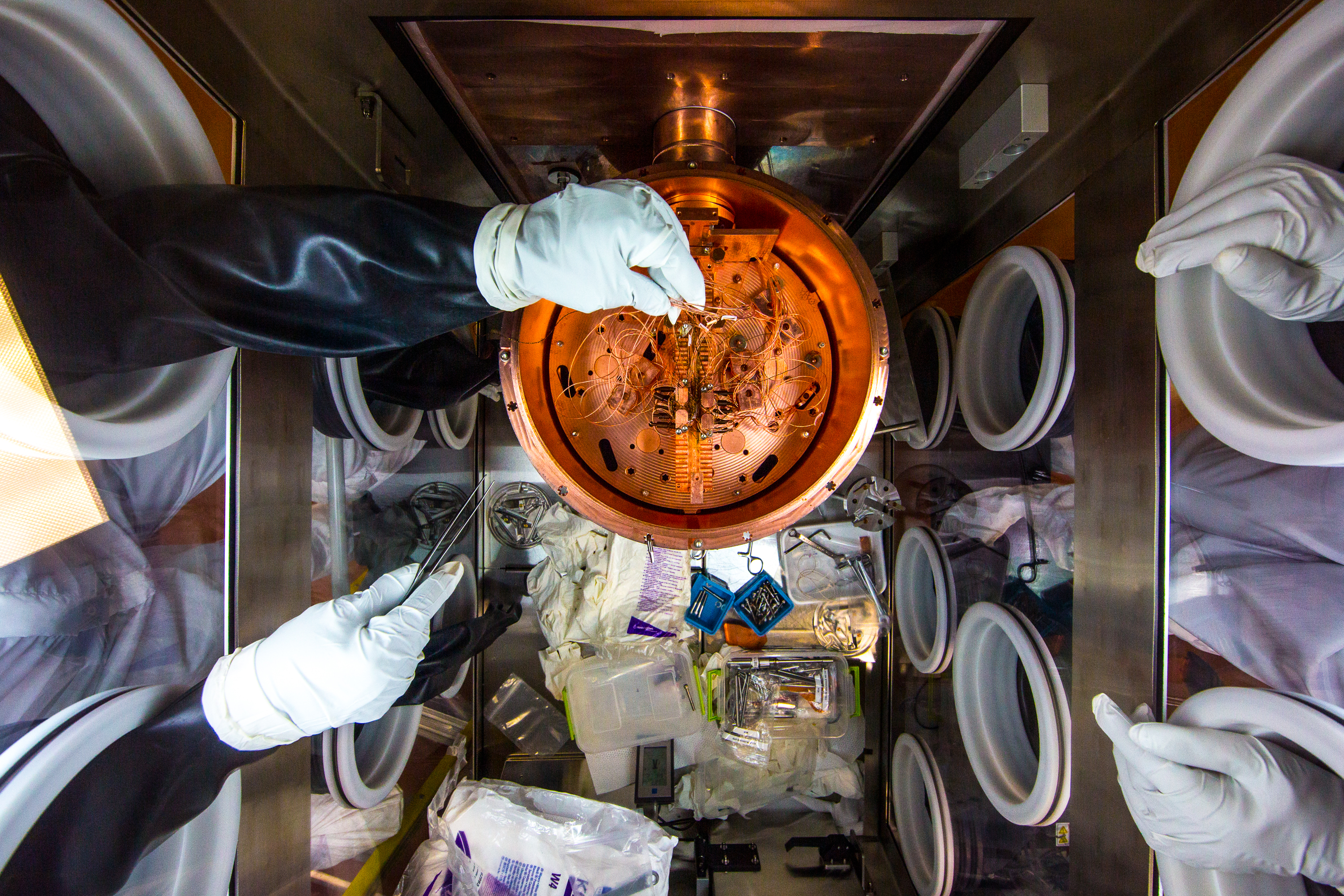 Researchers work on the Majorana Demonstrator’s inner detectors in a glovebox in a cleanroom on SURF’s 4850 Level. Photo by Matthew Kapust 