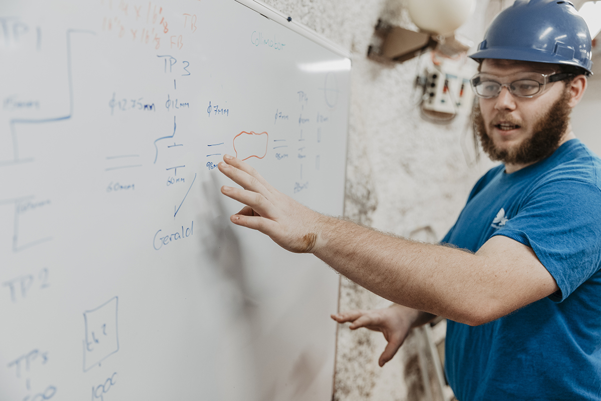 Researcher explains markings on a whiteboard