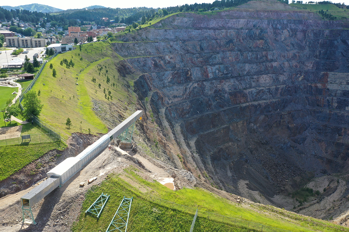The last segment of the conveyor juts out into the Open Cut, a large pit in the earth. 