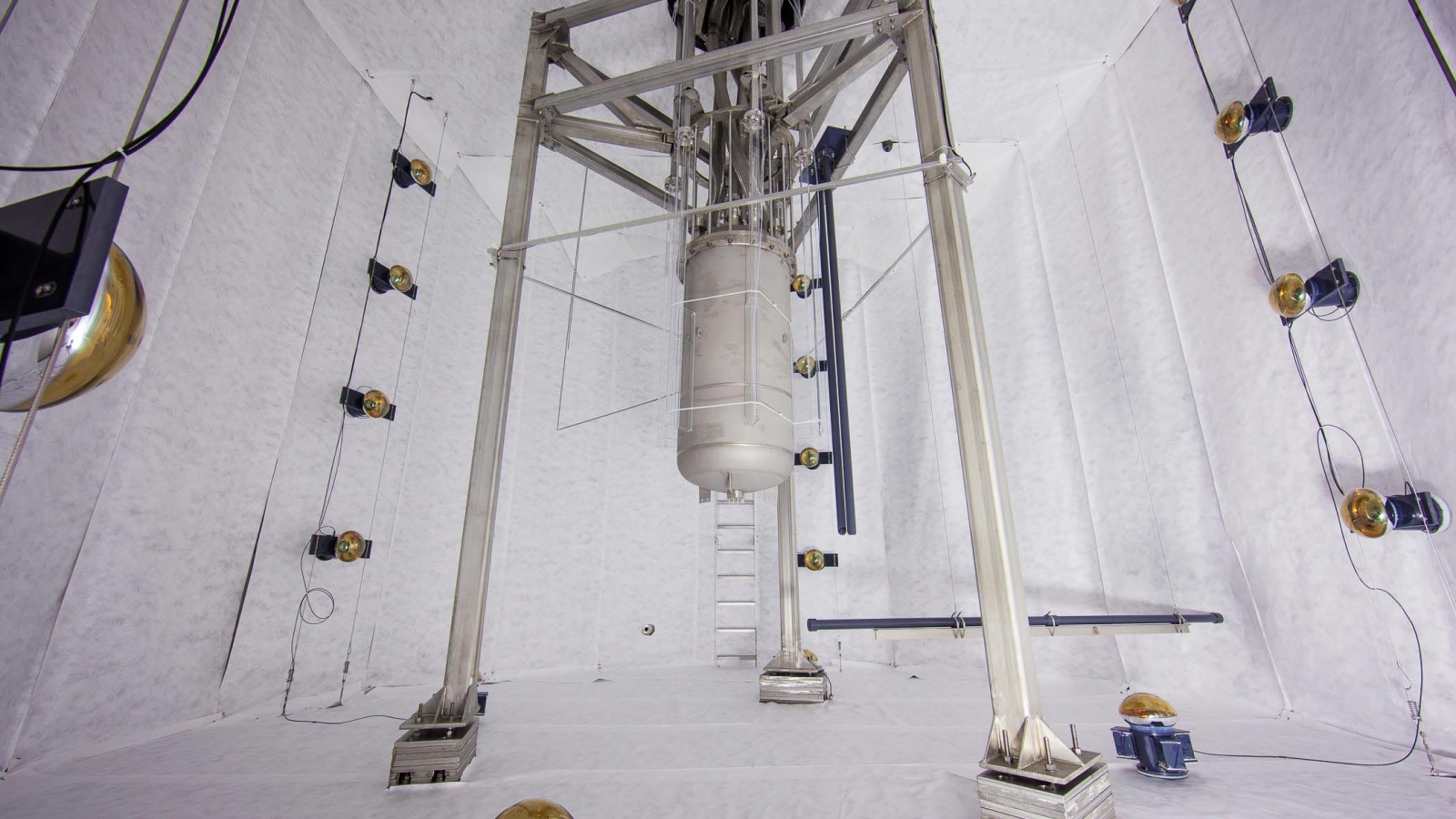 The LUX dark matter detector seen here suspended in its protective water tank, before water is added.