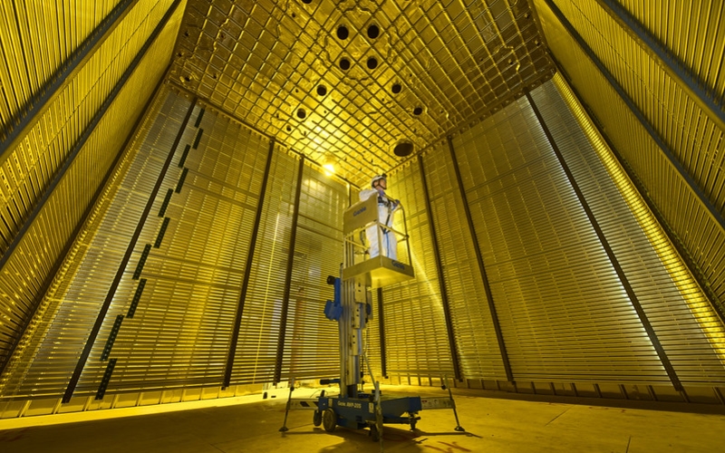 A researcher stands on a lift in the ProtoDUNE detectors at CERN