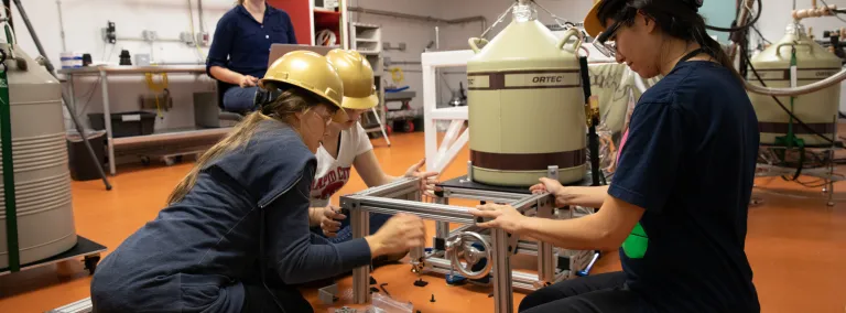 Students put the finishing touches on a detector in the BHUC.