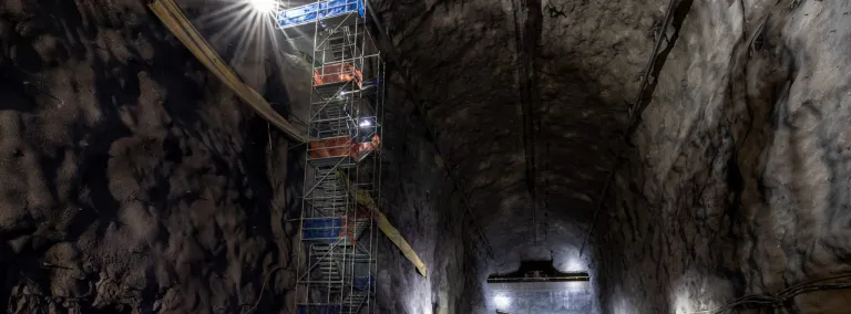 This image shows a colossal cavern, more than 500 feet long and about seven stories tall that will house the gigantic particle detector modules of the Deep Underground Neutrino Experiment. A six story scaffolding is on t he left of the image. 