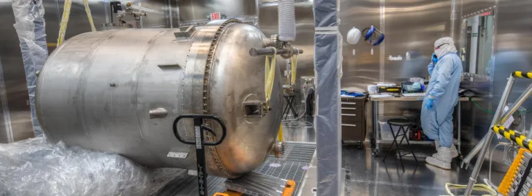 Cryostat and researcher in a clean room. 