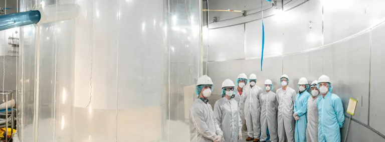 Members of the LZ team in the LZ water tank after the outer detector installation.