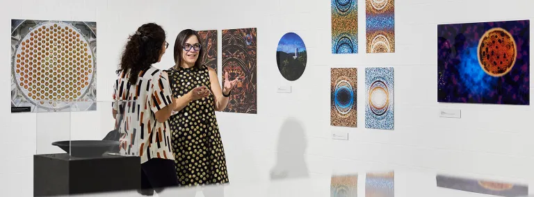 Gina Gibson, a professor at Black Hills State University, and the coordinator for the Artist in Residence (AiR) program at SURF speaks with a person at the new exhibition "UZHN/EARTH - Art and Science 1600 Meters Underground," at the University of Zurich’s (UZH) Science Pavilion on the Irchel Campus