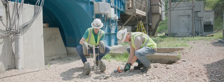 Two 2024 SURF interns work outdoors at the Oro Hondo shaft site in PPE