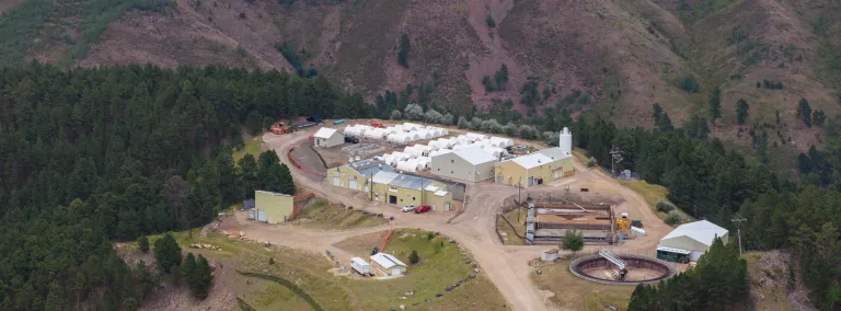 An image from above the SURF waster water treatment plant showing the facility, the gravel road, and the surrounding hills. 