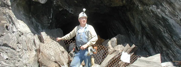 Tom Regan stands in front of a Mine opening