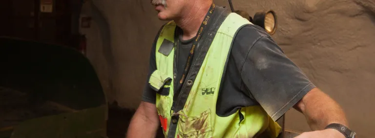 Kip Johnson in full PPE underground his clothes are a little muddy from the work. 