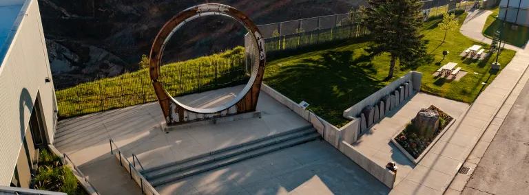 A aerial photo of the Davis Ring instillation outside of the Sanford Lab Homestake Visitor Center overlooking the Open Cut in Lead. 