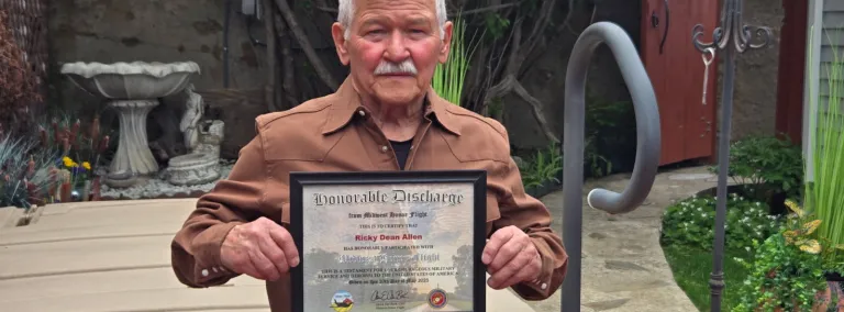 Ricky Allen holding his honor flight certificate 