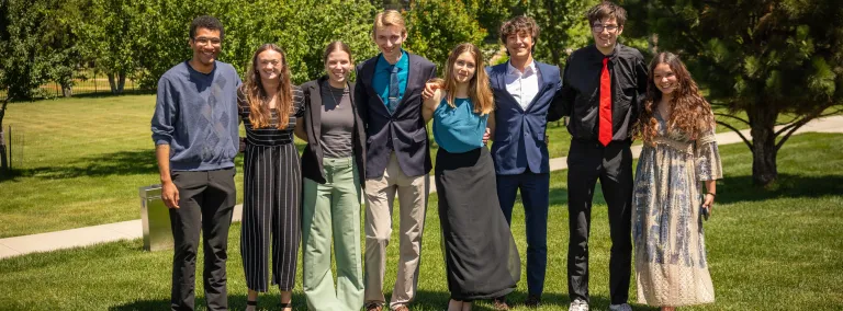 The 2025 cohort of Davis-Bahcall Scholars pose for a group photo outside on the grass..