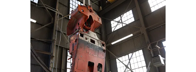 A large piece of equipment hanging from a crane inside the headfram at SURF. 