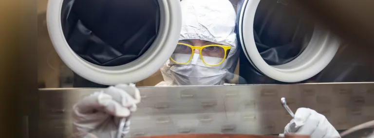 Ryan Cantz works inside a clean glove box inside the electroforming labratory at SURF