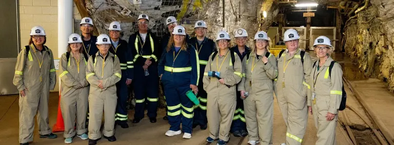 A group of people in PPE and overalls at the 4850 level of SURF. 