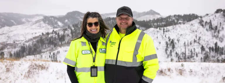 Dan Pierce & Robyn Varland pose outside in the winter of 2025