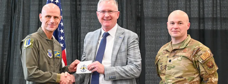 During a luncheon recognizing the new Honorary Commanders at Ellsworth, Col. Erick D. Lord, 28th Bomb Wing commander shakes hands with Mike Headley, SDSTA Executive Director and SURF Laboratory Director. Lt. Col. Daniel J. Moritz, 28th Logistics Readiness Squadron commander, who will be working with Headley during the program, stands alongside. Airman 1st Class Cameron B. Williams / Ellsworth Air Force Base