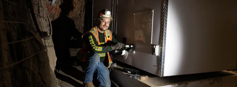 Nate Sanchez a plumbing contractor with Harrison Western working to install a bathroom pod on the 4850 Level of SURF. 