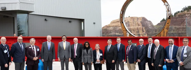 Dignitaries and officials celebrate a major milestone for the Deep Underground Neutrino Experiment on May 7. The event marked the start of 10 million pounds of steel beams being lowered underground to form the DUNE detectors. Photo credit: Landin Burke, 605 Media & Entertainment.