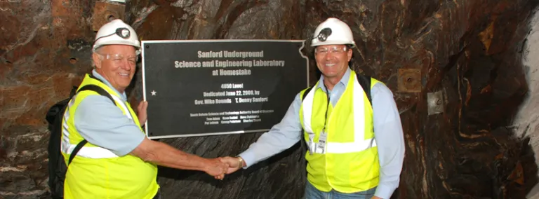 T Denny Sanford and Mike Rounds shake hands at Governor's corner in 2009