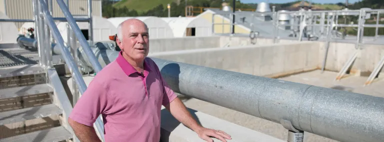 Todd Hubbard speaks with his hand on the pool for MMBR at the WWTP at SURF. 