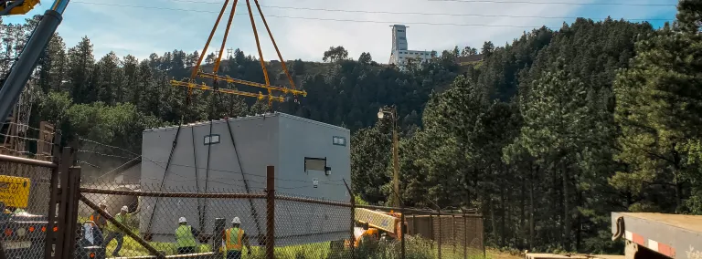 crane lowers the prefabricated E-House