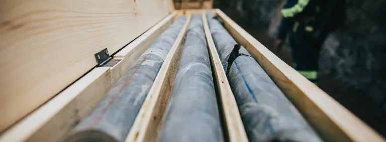 three cylinders of rock core in a box