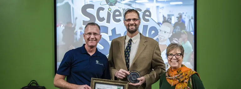 Mike Headley and Constance Walter present the CORES Award to "Science" Steve Rocusek in 2019.