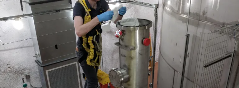 Researcher connects test cryostat