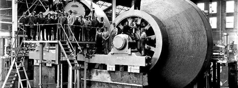 black and white photo of hoists with engineers and workers in the Nordberg Manufacturers plant