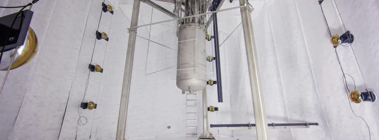 The LUX dark matter detector seen here suspended in its protective water tank, before water is added.