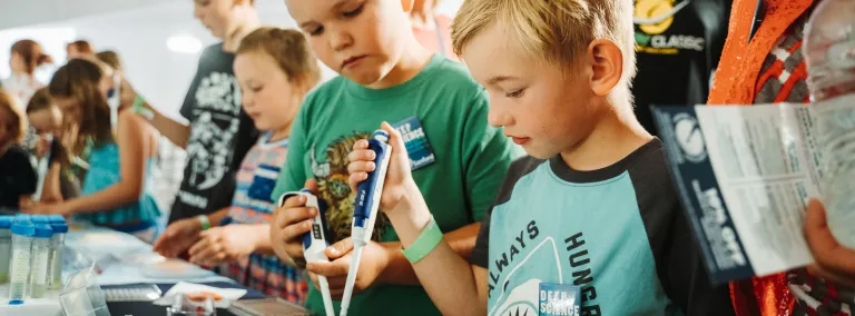 Kids examining science materials 