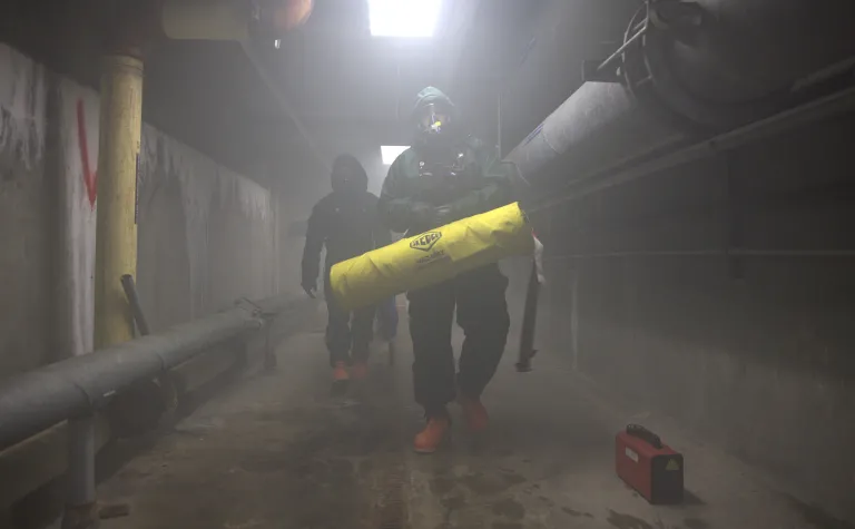 SD Natioanl Guard Training with SURF in a foggy tunnel workiing in hasmat suits.