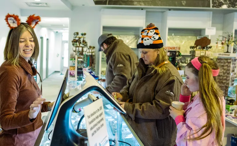 People making a purchase in the the museum store.