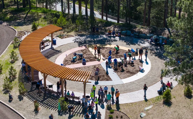 A group gathered at the Garden planting event at Čhaŋgléška Wakȟáŋ.