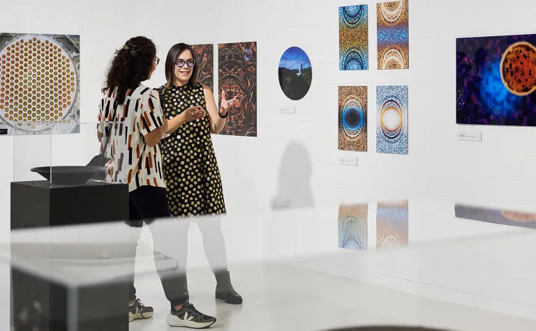 Gina Gibson, a professor at Black Hills State University, and the coordinator for the Artist in Residence (AiR) program at SURF speaks with a person at the new exhibition "UZHN/EARTH - Art and Science 1600 Meters Underground," at the University of Zurich’s (UZH) Science Pavilion on the Irchel Campus