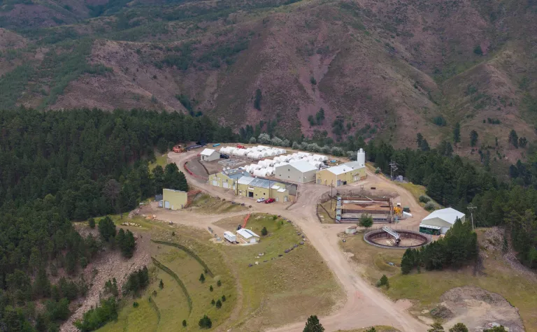 An image from above the SURF waster water treatment plant showing the facility, the gravel road, and the surrounding hills.