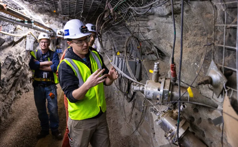 Dr. Chet Hopp, with LBNL, is one of many researchers involved in CUSSP points to one of the monitoring boreholes used in the experiment 