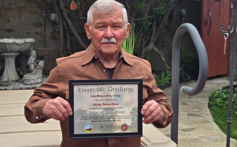 Ricky Allen holding his honor flight certificate 