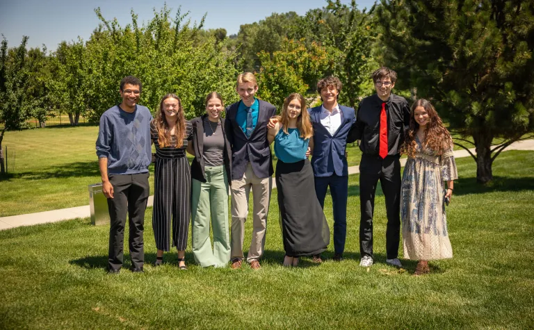 The 2025 cohort of Davis-Bahcall Scholars pose for a group photo outside on the grass..