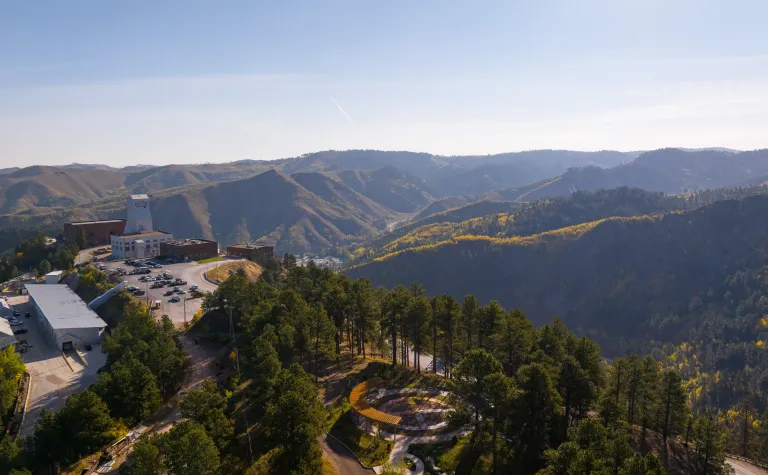 D drone show above the Yates Campus at SURF showing the headframe, Hoistroom, Rounds Operation Center and Čhaŋgléška Wakȟáŋ in the fall colors.. 