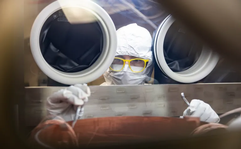 Ryan Cantz works inside a clean glove box inside the electroforming labratory at SURF